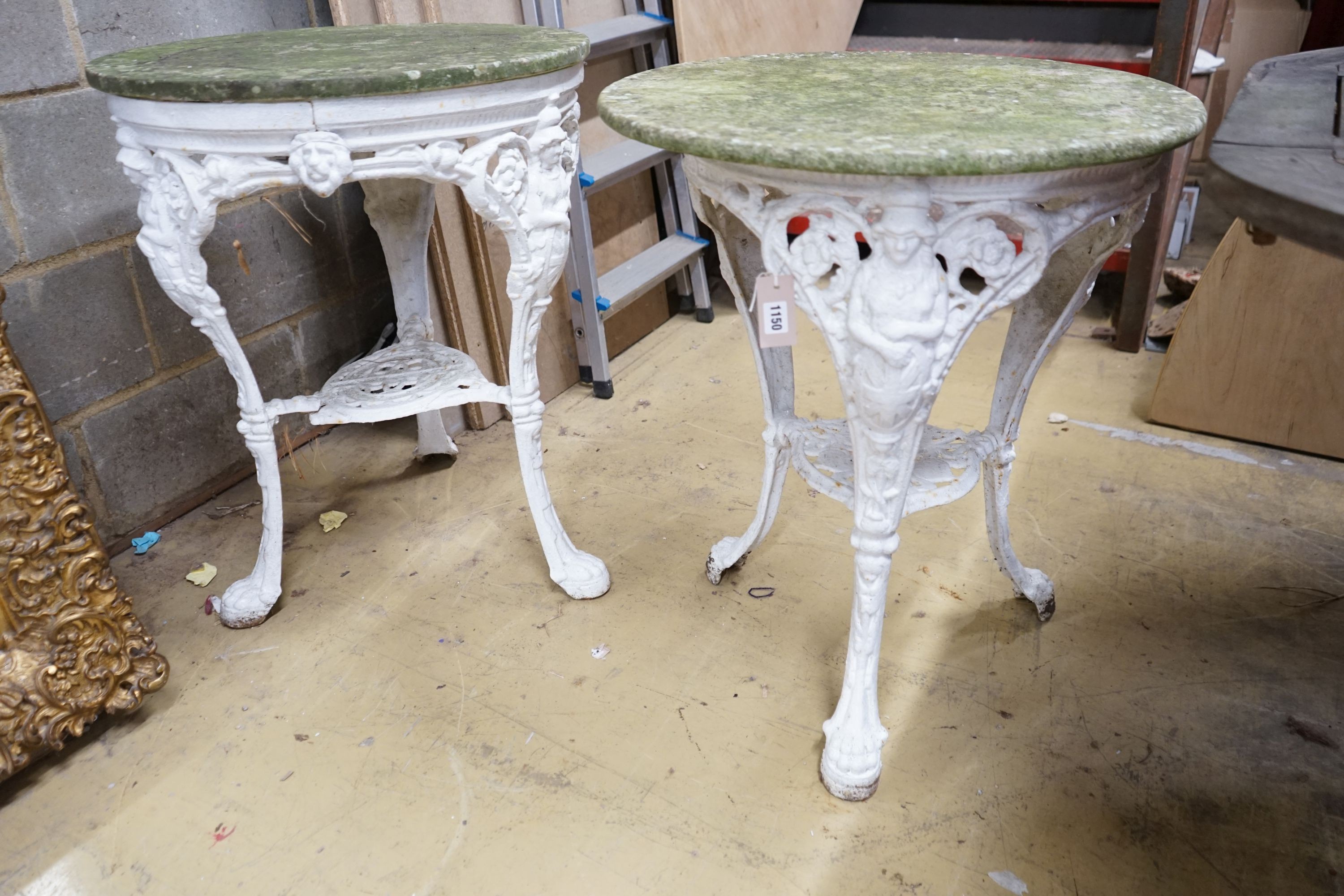 A pair of cast iron circular marble top tables, diameter 60cm, height 72cm